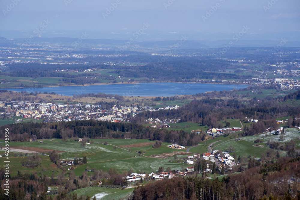 Panoramic landscape with lake Pfäffikon in the background, seen from mountain Bachtel. Photo taken April 8th, 2021, Zurich, Switzerland.