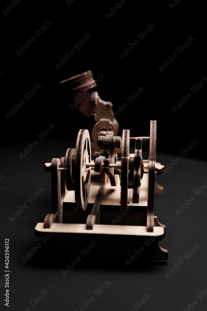 A wooden engine on a black background close-up