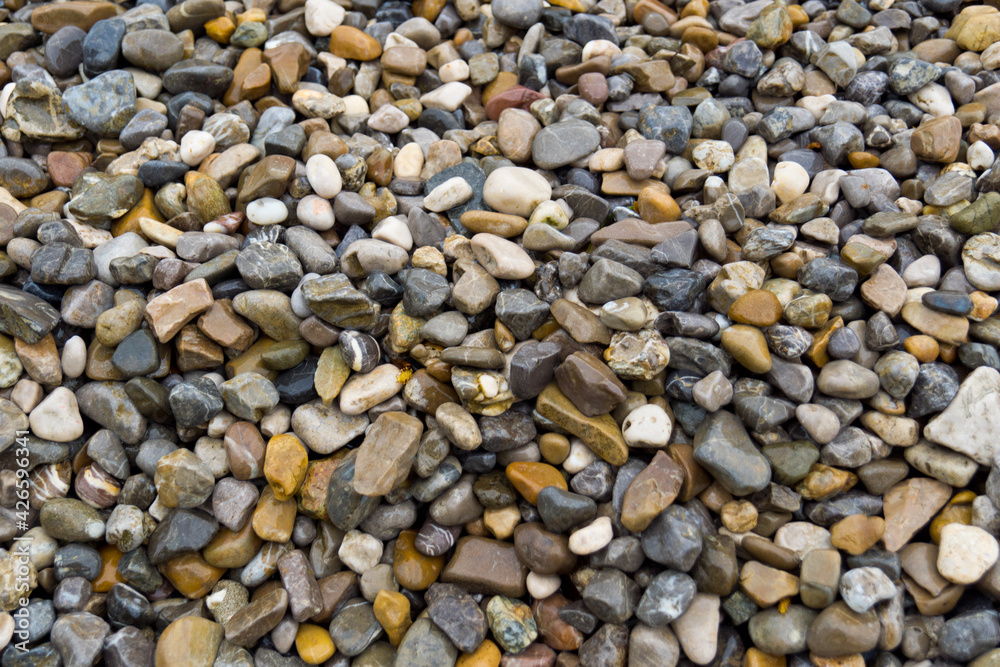 round and edgy gravel stones on the beach round and edgy gravel stones on the beach