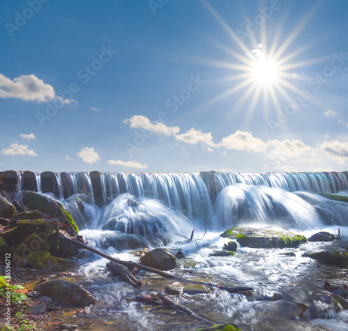 Fototapeta Naklejka Na Ścianę i Meble -  small waterfall on river under a sparkle sun
