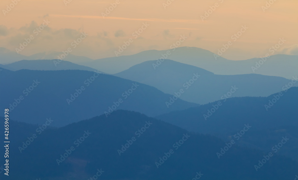mountain chain silhouette in blue mist, natural mountain background