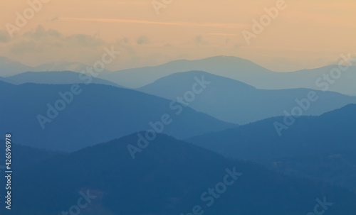 mountain chain silhouette in blue mist, natural mountain background
