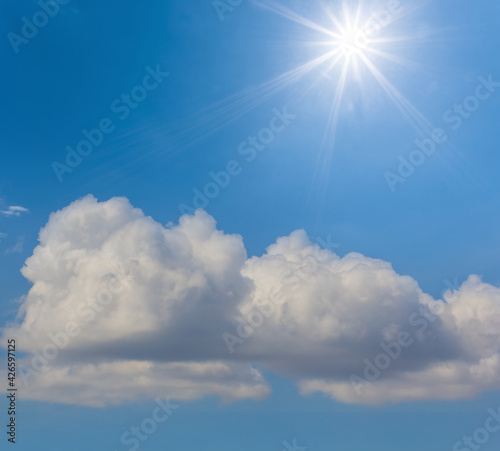 blue sky with cumulus clouds and sparkle sun  summer natural background