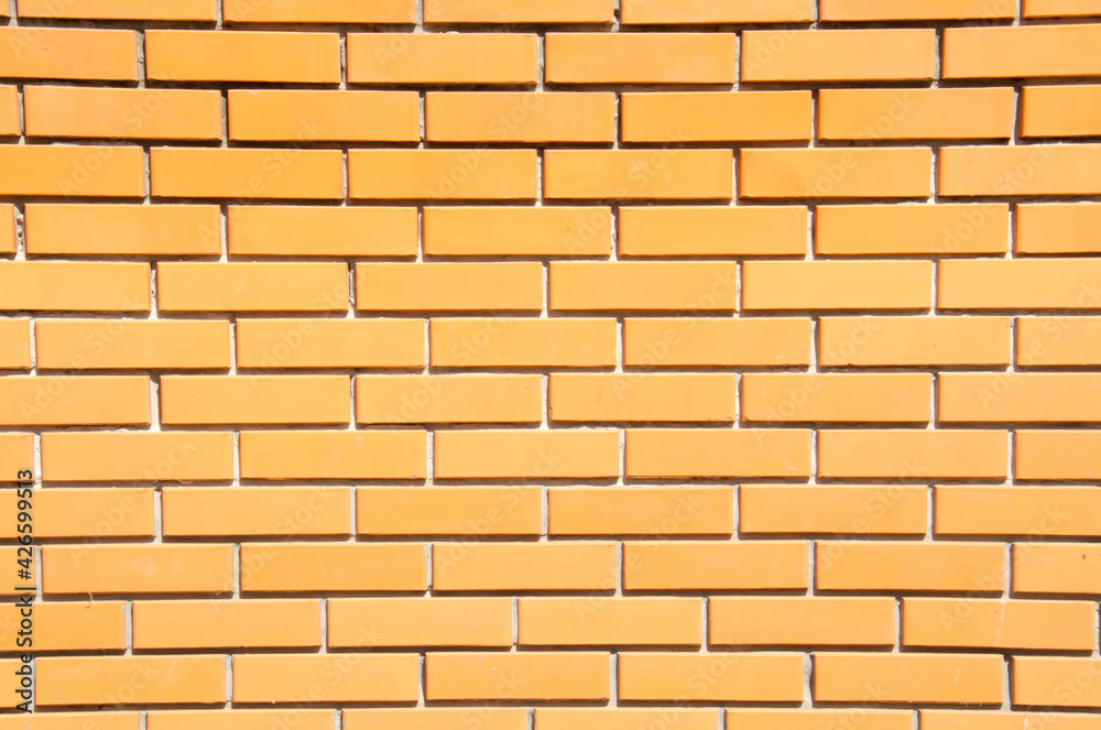 Close-up orange brick wall with copy space. Grunge brick wall background. Terracotta brick wall for texture. Decorative brick wall surface. Close-up orange brick wall with copy space. Grunge brick wall background. Terracotta brick wall for texture. Decorative brick wall surface.