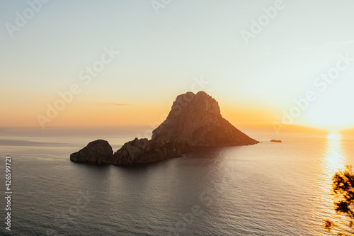 Es Vedra at the sunset, pastel colored sky at the mystic rock of Es Vedra, Ibiza Island. Sunset in Sant Josep of Balearic Islands