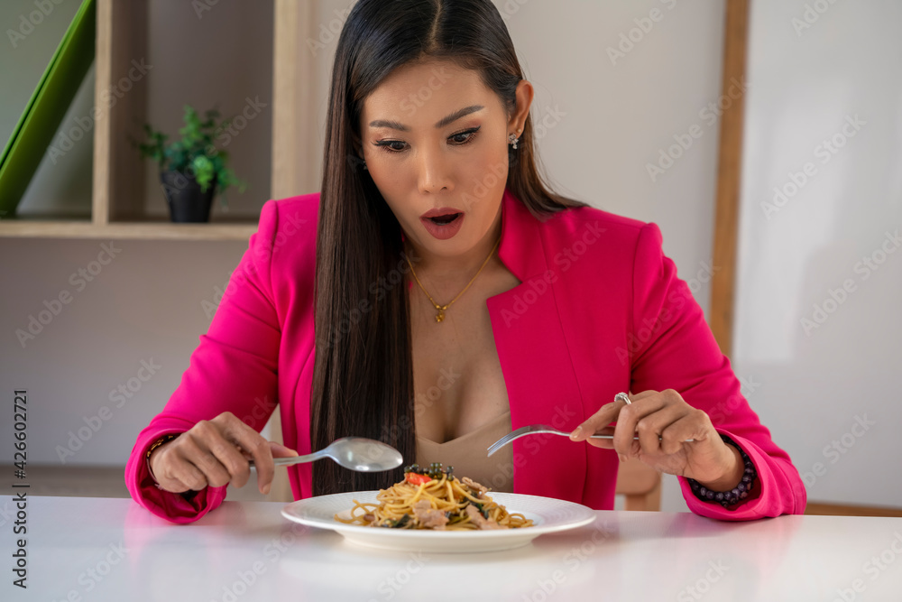 Hungry people eating spaghetti. A plate of pasta and a fork wildly eats pasta.