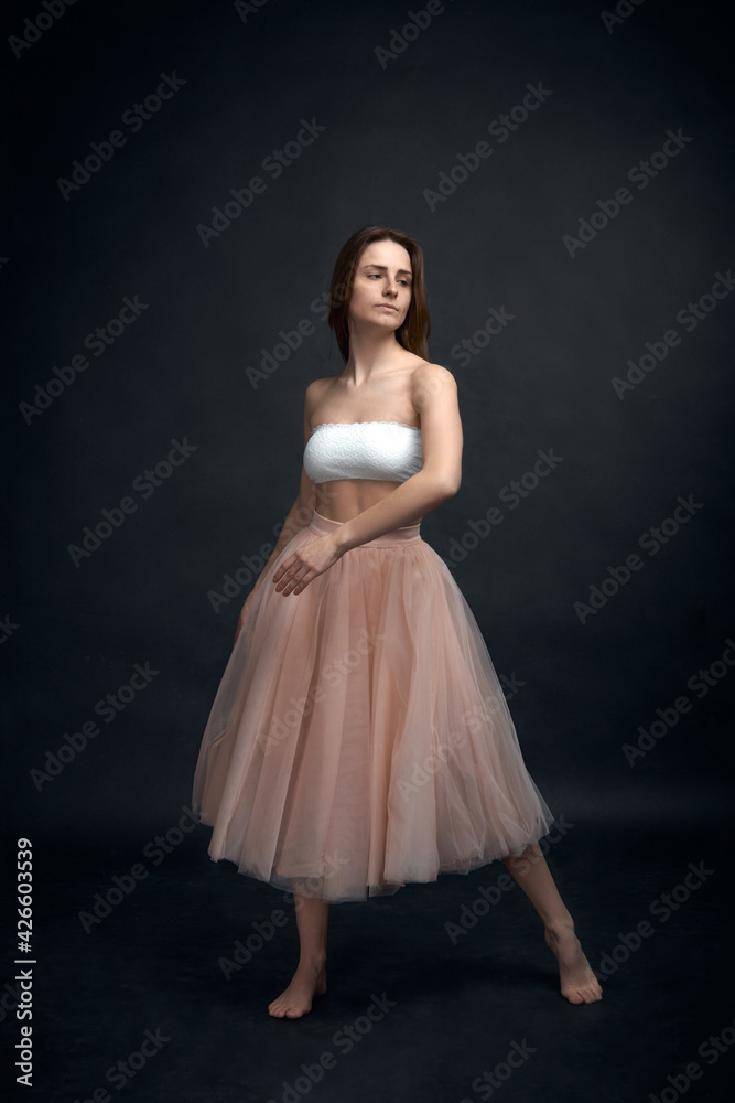 Young girl in white top and peach skirt dancing Young girl in white top and peach skirt dancing