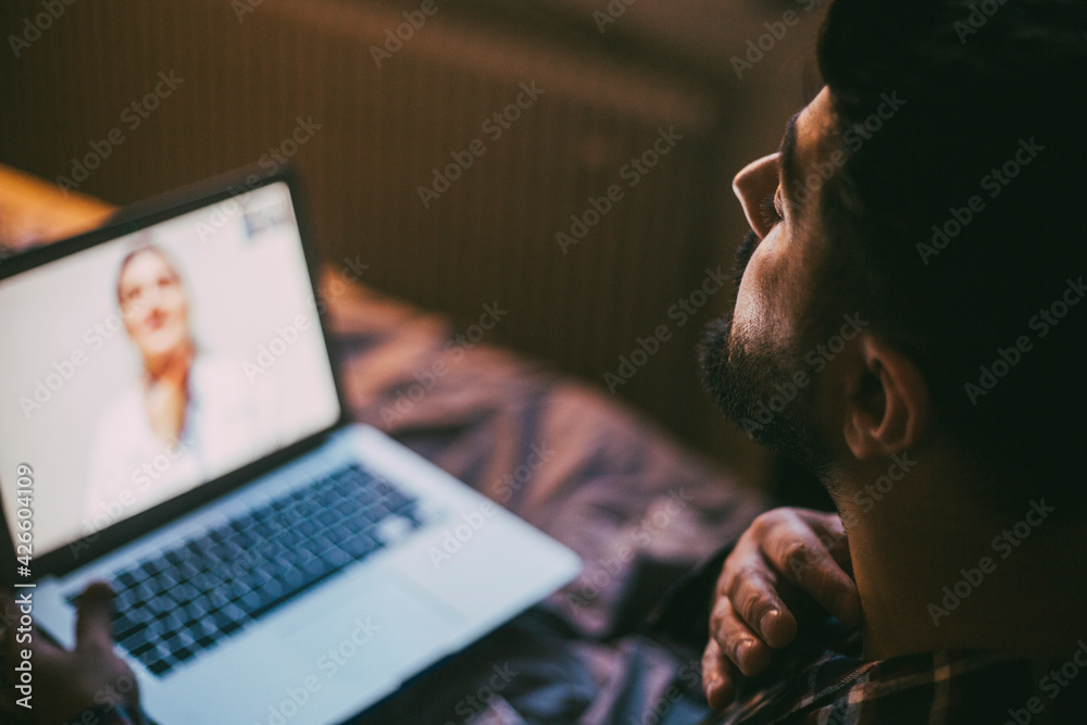 Sick man consulting online through video call with doctor at home Sick man consulting online through video call with doctor at home