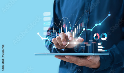 Businessman trading online stock market on teblet screen, digital investment concept
