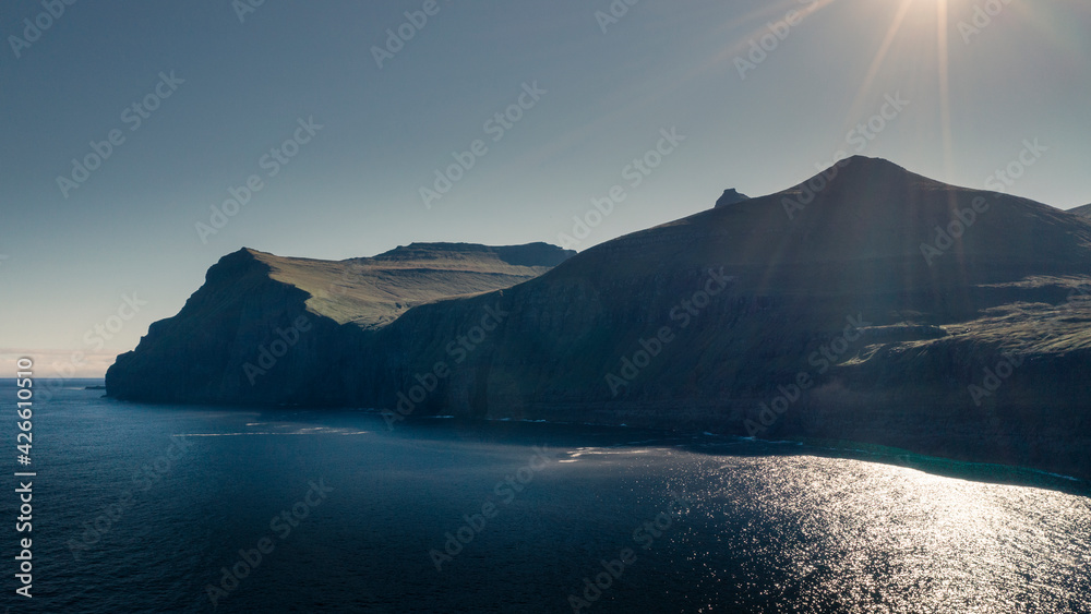 Panoramic coastline of island Eysturoy on the Faroe Islands, with ocean, green cliffs and blue sky. Panoramic coastline of island Eysturoy on the Faroe Islands, with ocean, green cliffs and blue sky.