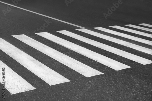 White pedestrian crossing on empty city street © New Africa