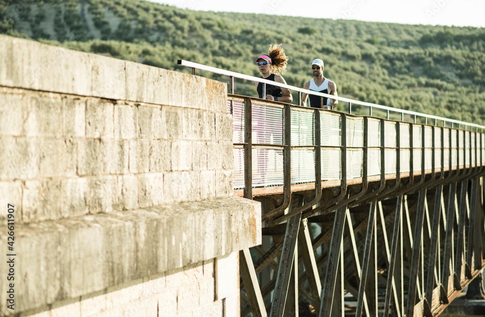 triathlon runners triathlon runners compete on a bridge in sunny image triathlon runners triathlon runners compete on a bridge in sunny image