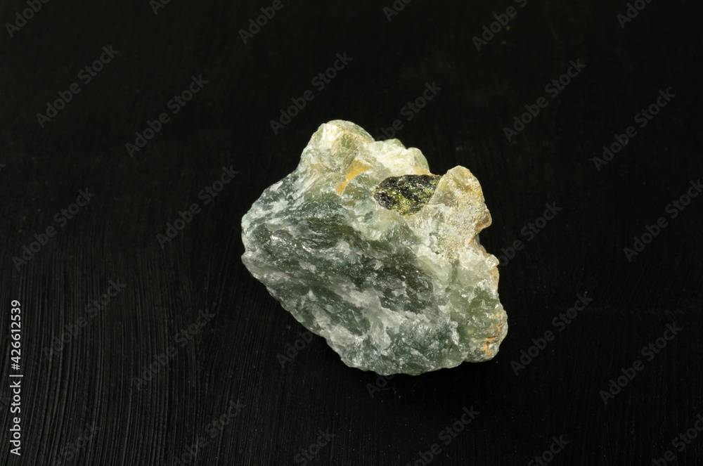Prehnite green natural mineral stone from Republic of South Africa RSA on black background. Mineralogy, geology, magic of stones, semi-precious stones and samples of minerals. Close-up macro photo. Prehnite green natural mineral stone from Republic of South Africa RSA on black background. Mineralogy, geology, magic of stones, semi-precious stones and samples of minerals. Close-up macro photo.