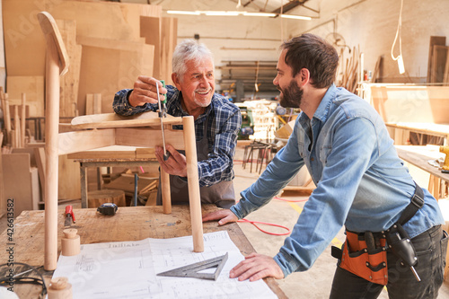 Senior craftsman works on a chair