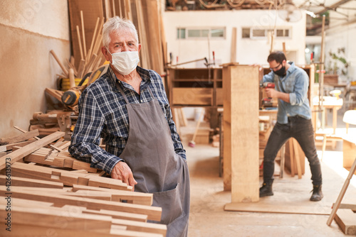 Senior craftsman with face mask because of Covid-19