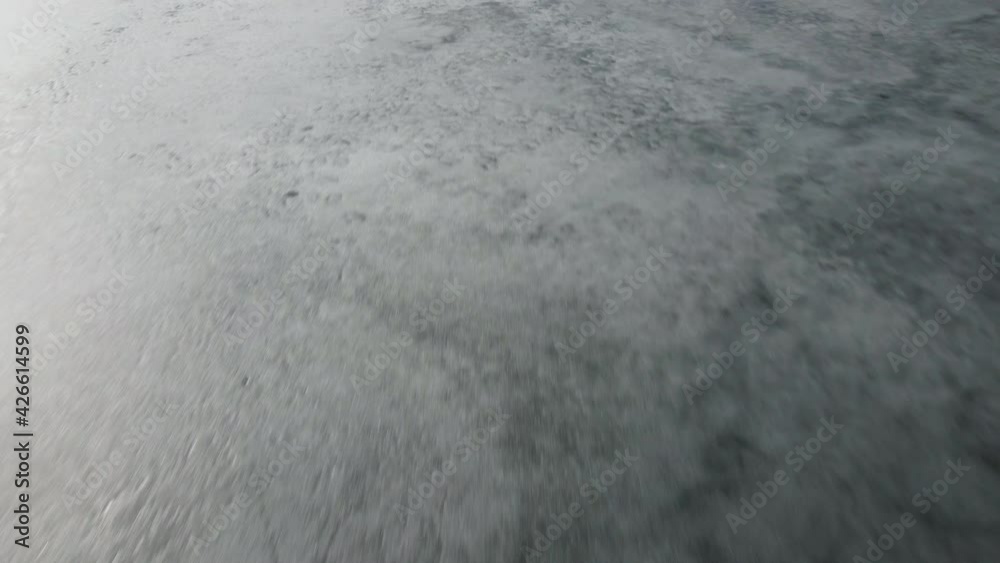 Fast and Speedy Close-up drone view on ice on the lake or river. Cracking and melting ice on water. Fast and Speedy Close-up drone view on ice on the lake or river. Cracking and melting ice on water.