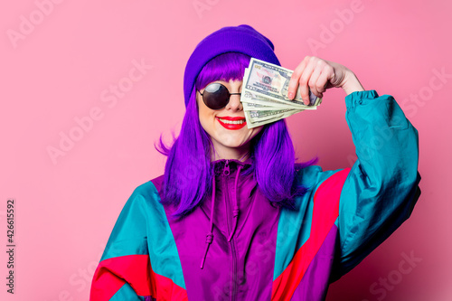 Stylish white girl with purple hair and 80s tracksuit hold cash money