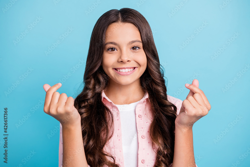 Portrait of curly hairstyle person toothy smile fingers show money rich wear dotted isolated on blue color background Portrait of curly hairstyle person toothy smile fingers show money rich wear dotted isolated on blue color background