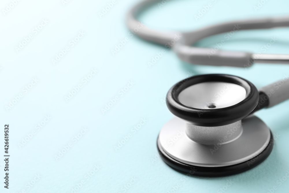 Stethoscope on light blue background, closeup. Space for text Stethoscope on light blue background, closeup. Space for text