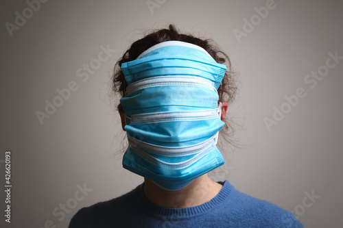 Konstfotografi Girl with multiple medical masks on her face