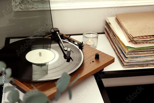 Cuadro en lienzo Stylish turntable with vinyl record on table indoors