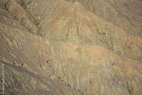 The soil of Mount Bromo active volcano at Bromo Tengger Semeru National Park, close up of rocks structure, made from volcanic ash, lava and other geologic materials photo