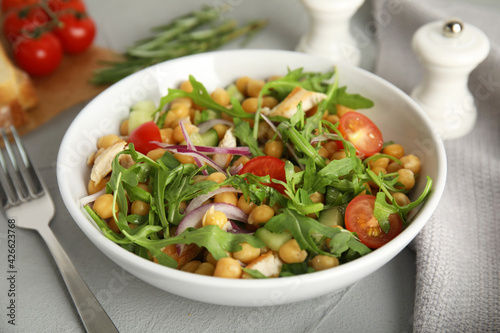 Delicious fresh chickpea salad on light grey table