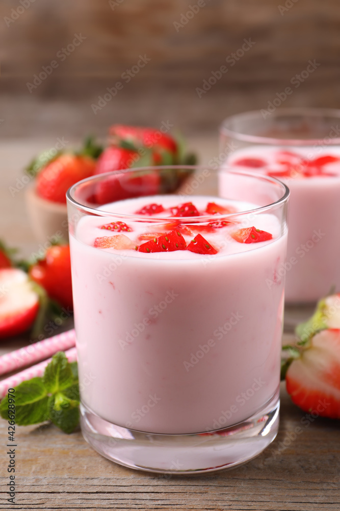 Yummy drink with strawberries on wooden table Yummy drink with strawberries on wooden table