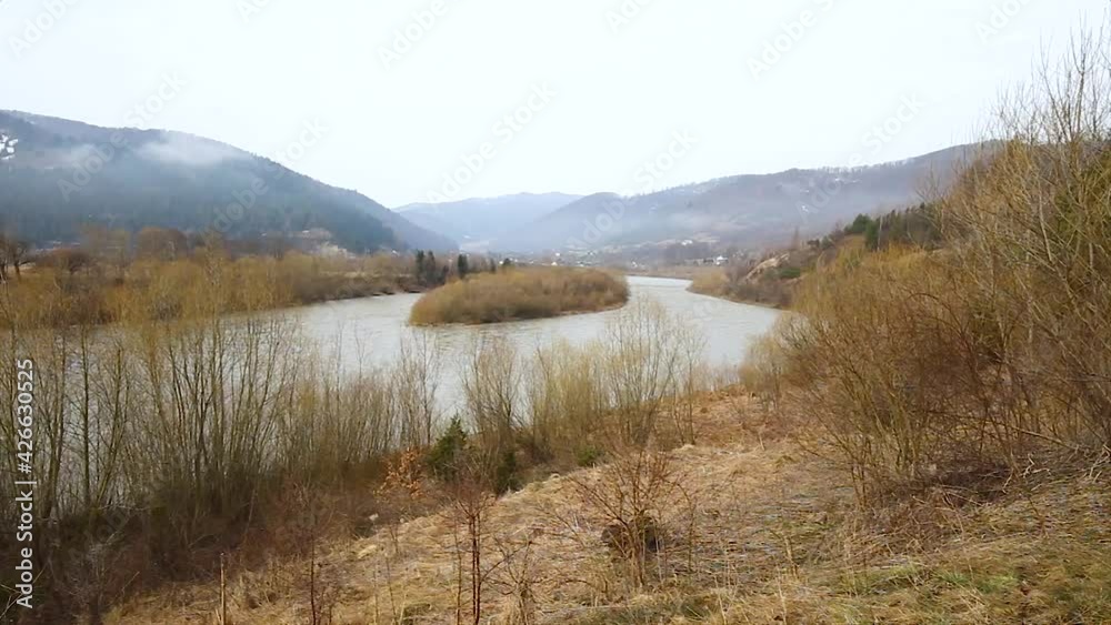 Foggy morning in the Carpathians overlooking a mountain river and mountain ranges. Unique landscape of the Ukrainian Carpathians overlooking the river Stryi.