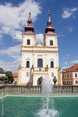 Water fountain on the square in Kadan in the Czech Republic in front of the church .