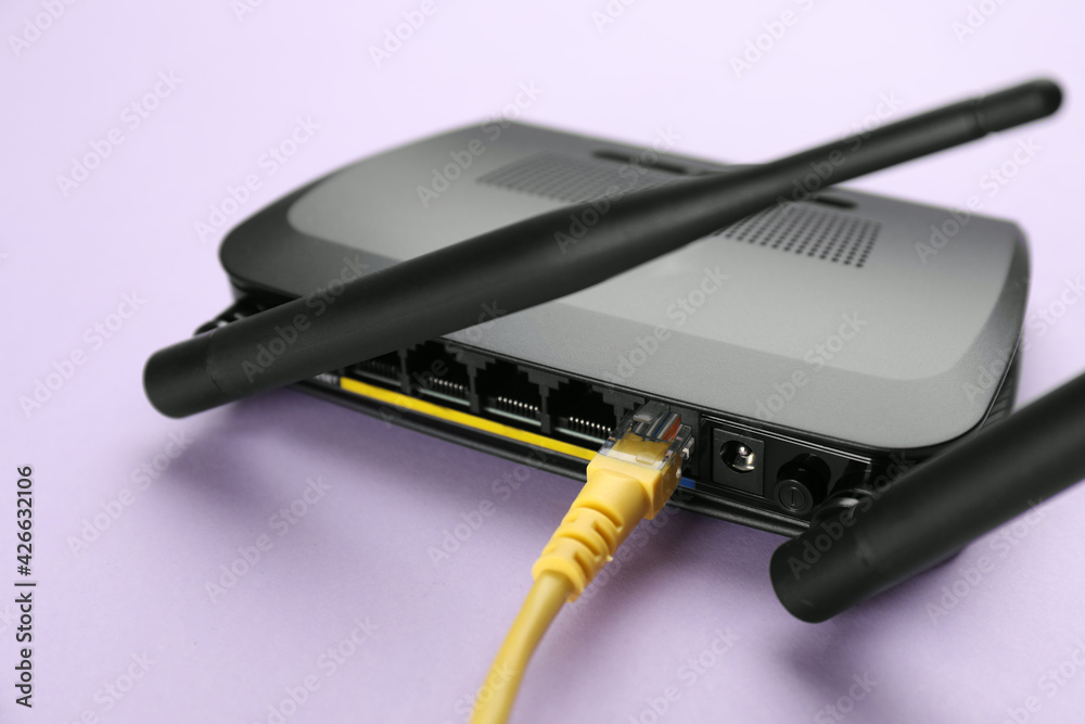 Modern Wi-Fi router on lilac background, closeup Modern Wi-Fi router on lilac background, closeup