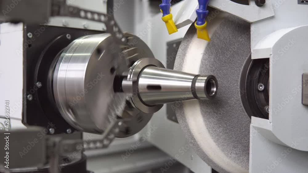 The CNC high accuracy surface cylindrical grinding machine with the steel shaft of finishing process for industrial metal work at factory