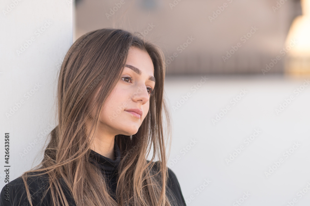 Sad looking lonely young woman looking away absorbed in thoughts Sad looking lonely young woman looking away absorbed in thoughts