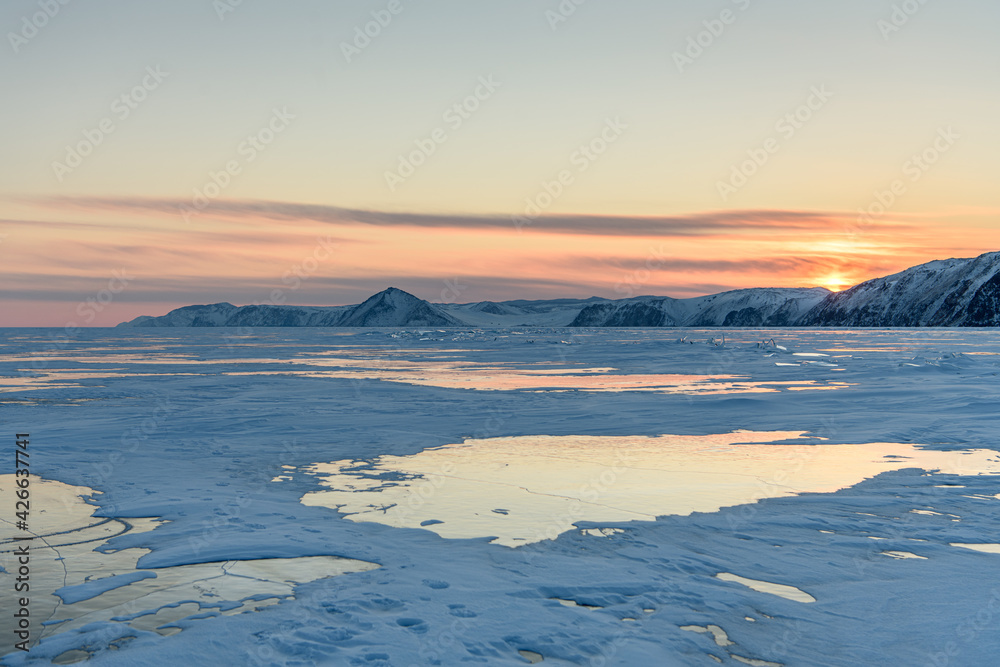 Sunset above Baikal lake in winter. Irkutsk Region, Russia