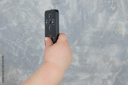 Wallpaper Mural baby hand with remote control Torontodigital.ca