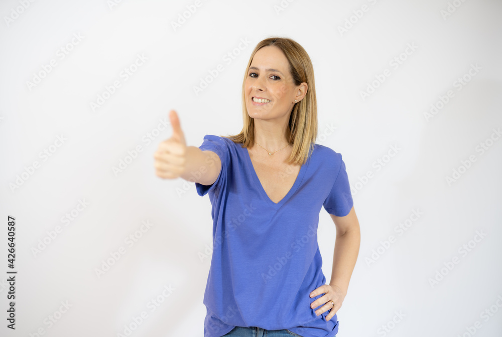 Smiling pretty young woman showing thumb up isolated over white background Smiling pretty young woman showing thumb up isolated over white background