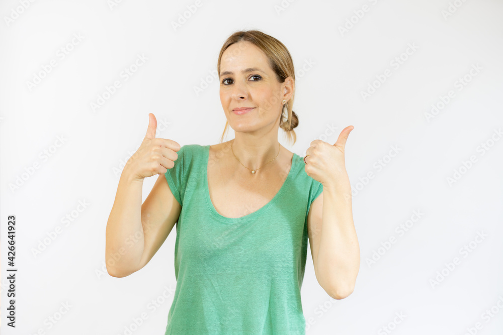 Smiling pretty young woman showing thumbs up isolated over white background Smiling pretty young woman showing thumbs up isolated over white background