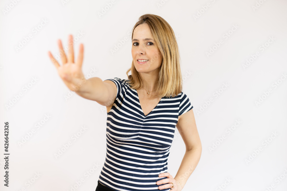 Portrait of smiling young woman in striped t-shirt counting four with fingers isolated over white background. Portrait of smiling young woman in striped t-shirt counting four with fingers isolated over white background.