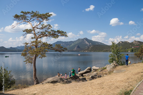 Tourists have a rest on the lake Borovoe, Burabay (Borovoye) is a climatic and medical resort, a resort village in Kazakhstan photo