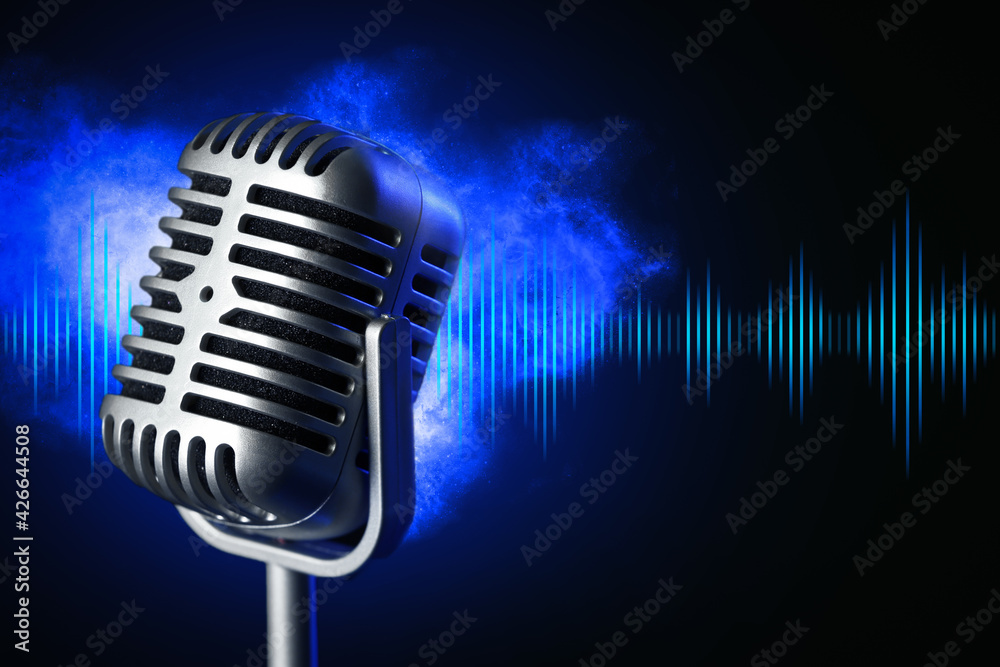 Retro microphone with radio waves on dark background Photos | Adobe Stock