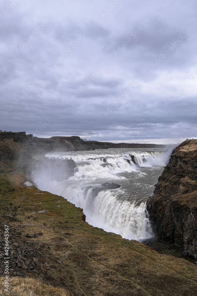 Famous Gulfoss waterfall in the Golden Circle in South Iceland. Vertical photo Famous Gulfoss waterfall in the Golden Circle in South Iceland. Vertical photo