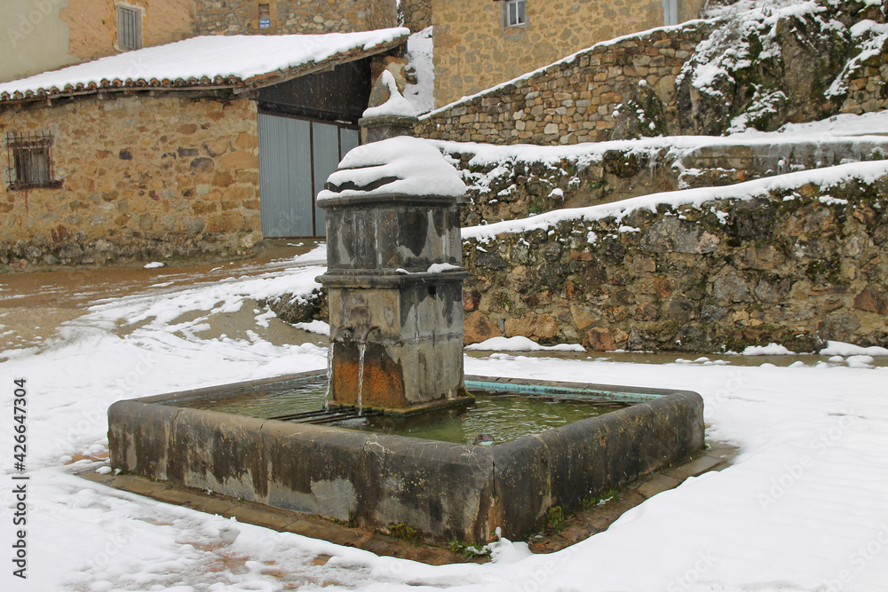 Old fountain under the winter snow in the town of Ferreras del Puerto, Leon Spain Old fountain under the winter snow in the town of Ferreras del Puerto, Leon Spain