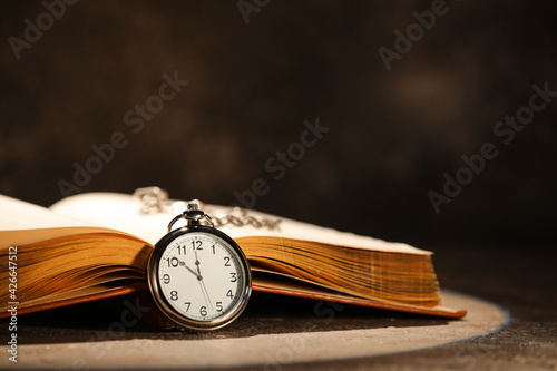 Open old book with clock on...