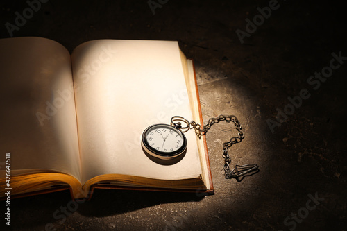 Open old book with clock on...