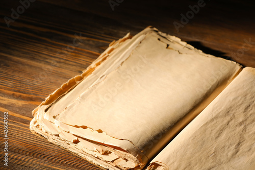 Open old book on wooden tab...
