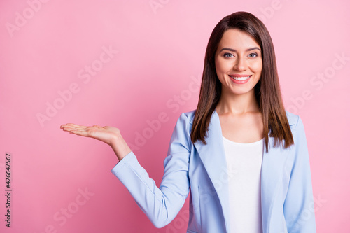 Photo of young beautiful happy smiling positive businesswoman hold hand demonstrate isolated on pink color background photo