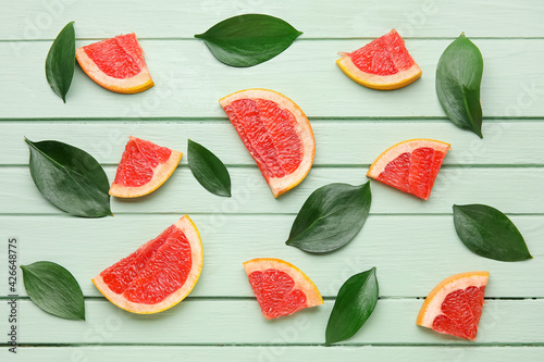 Fototapeta Naklejka Na Ścianę i Meble -  Fresh sliced grapefruit on color wooden background
