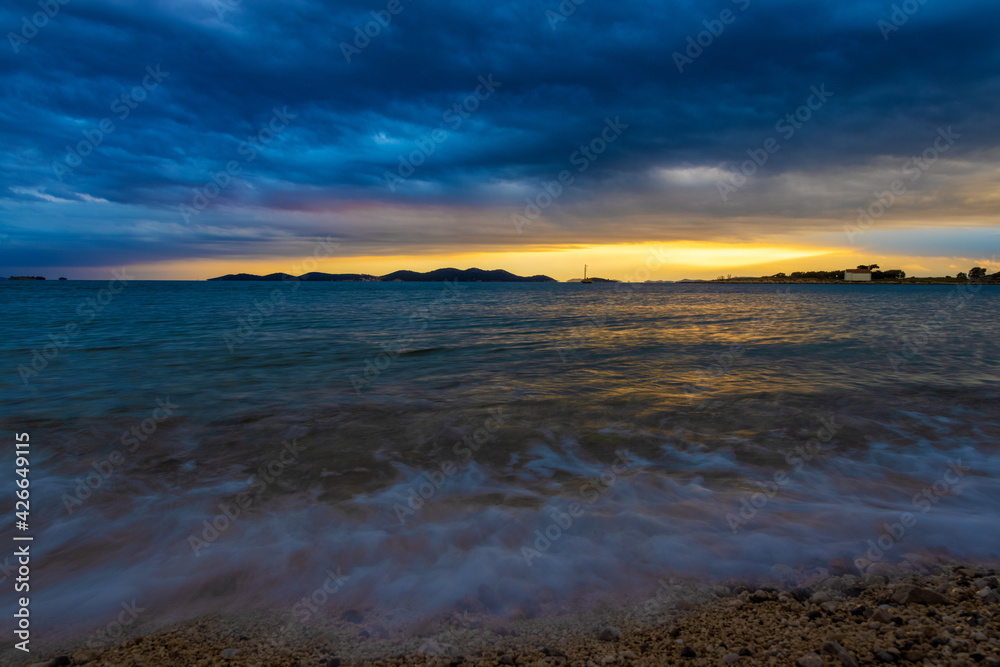 Heavy clouds and strong wind with waves in the evening on the Adriatic coast in Istra during sunset, Croatia
