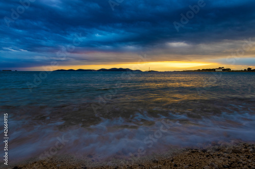 Heavy clouds and strong wind with waves in the evening on the Adriatic coast in Istra during sunset, Croatia 