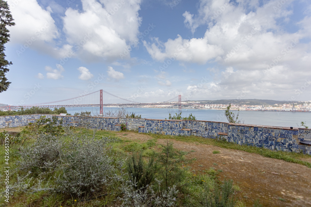 wide panorama overlooking the river and the big bridge on April 25 in Lisbon, Portugal